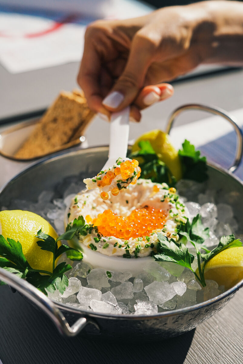 Caviar service over crushed ice with lemon and herbs